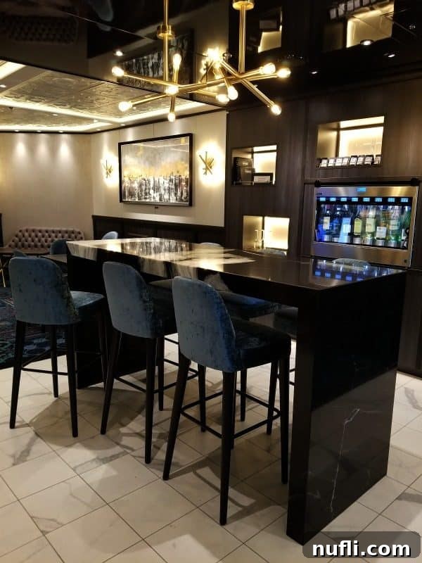The tranquil Library Bar with self-serve wine stations and comfortable blue chairs arranged around tall tables.