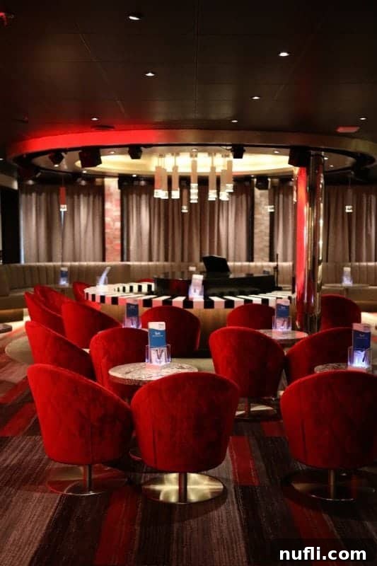 The classic Piano Bar setup on Carnival Horizon with a central piano and plush red chairs, ready for an evening of music and fun.