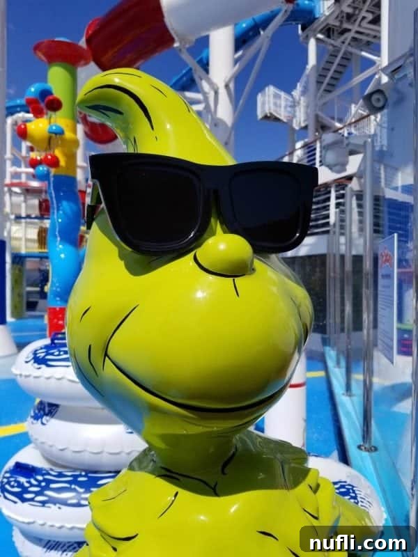 The Grinch character statue wearing cool sunglasses, adding to the playful Dr. Seuss theme at WaterWorks on the Carnival Horizon.