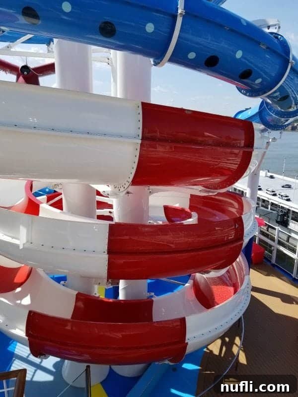 A vivid red and white spiral waterslide, part of the exhilarating Dr. Seuss WaterWorks, promising a fun descent.
