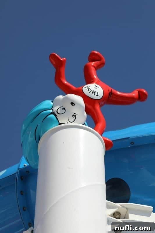 Thing 1 figurine positioned playfully near a waterslide, part of the immersive Dr. Seuss WaterWorks experience.