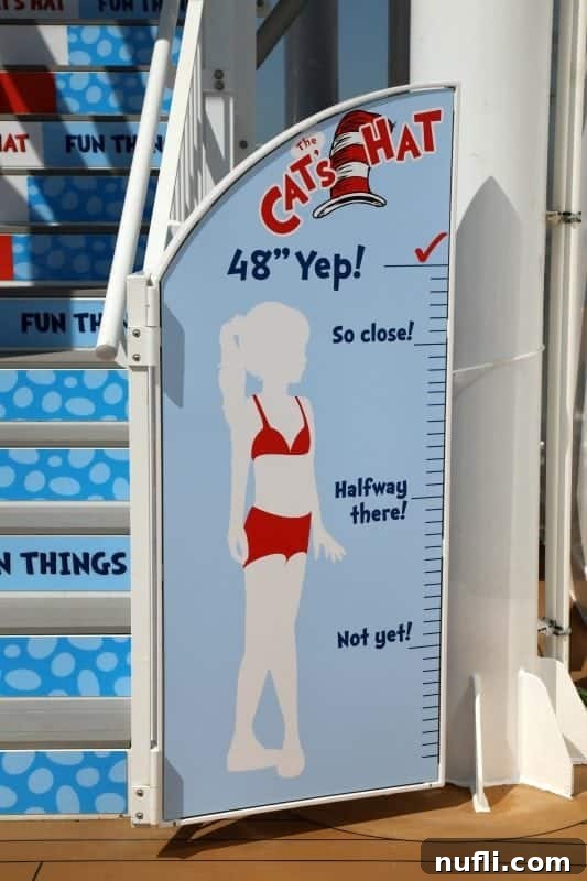 A height measurement sign featuring the Cat in the Hat character, indicating requirements for waterslide entry.