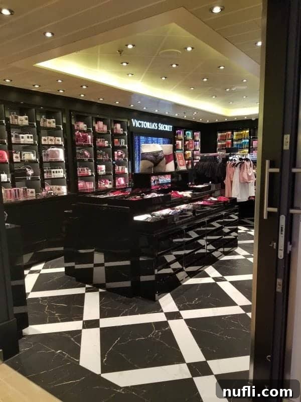 The elegant Victoria's Secret store display with an array of merchandise inside the Carnival Horizon atrium shops.