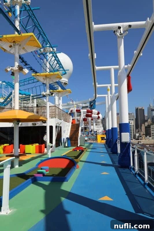 The bustling outdoor track and amusement area on the Carnival Horizon's SportSquare, with various activities in full swing.