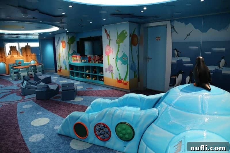 A vibrant kids play area within Camp Ocean, featuring an igloo and friendly penguin decorations with an Arctic theme.
