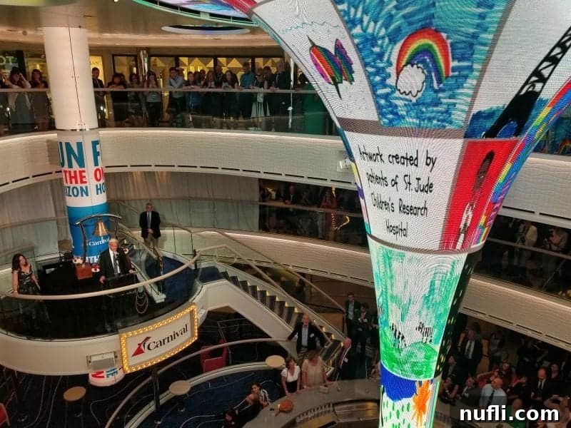 The magnificent Carnival Horizon atrium with its large central video funnel displaying dynamic visuals and elegant architecture.