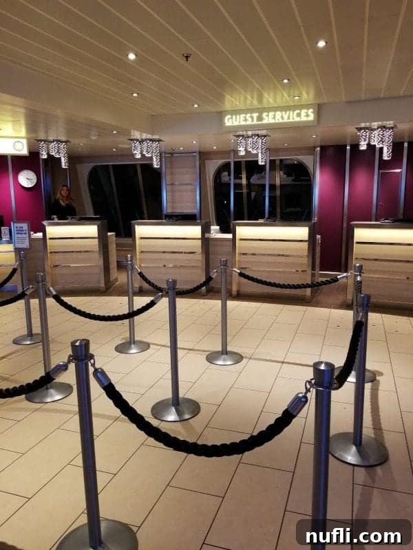 The welcoming and efficient Guest Services area on the Carnival Horizon, brightly lit and ready to assist passengers.