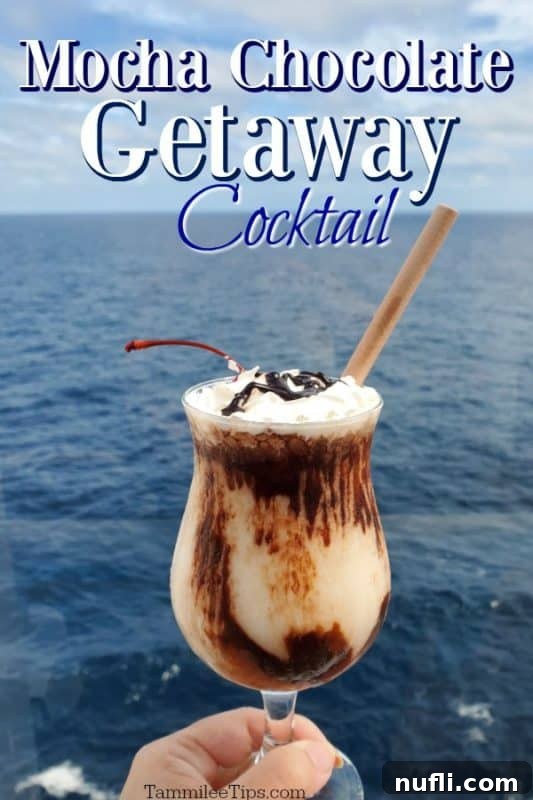 Decadent Mocha Retreat Cocktail 2 A refreshing Mocha Chocolate Getaway Cocktail, perfectly blended and garnished, held against a stunning backdrop of the sparkling blue ocean.