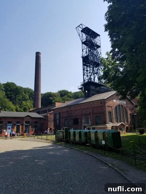 Ostrava's Vintage Wheels Adventure 7 Historic brick buildings and a towering structure at Landek Park, Ostrava