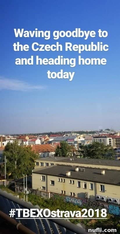 Scenic views of the Czech countryside from a train window, featuring rolling hills and distant towns