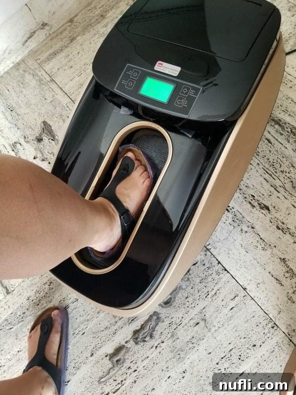 A foot clad in a Birkenstock sandal stepping into a shoe-wrapping machine