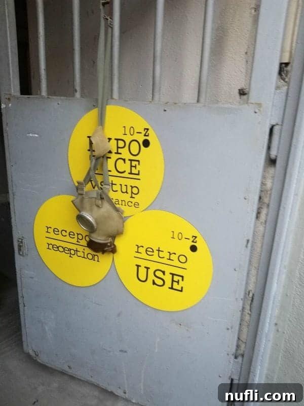 metal gate entrance with a gas mask hanging from it 