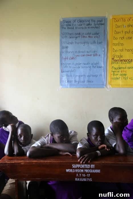 Joyful Ugandan school children gathered together, reflecting the positive impact of World Vision's educational programs.
