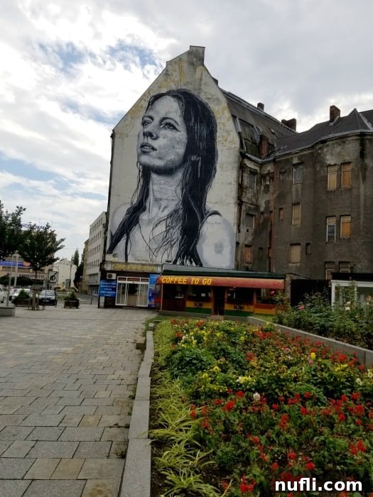 A vibrant mural on the streets of Ostrava, depicting the famous Madonna 'Ostravica' on a historic building, showcasing the city's street art scene.