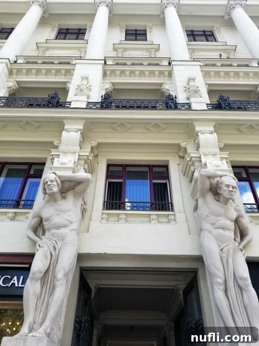 Exteior of the house of four giants with sculptures up the side 