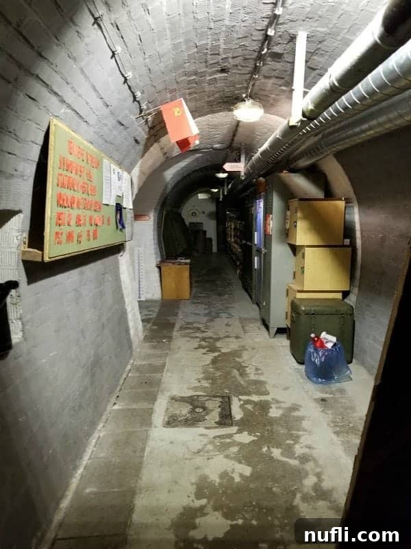 hallway through a nuclear war bunker with boxes and flags
