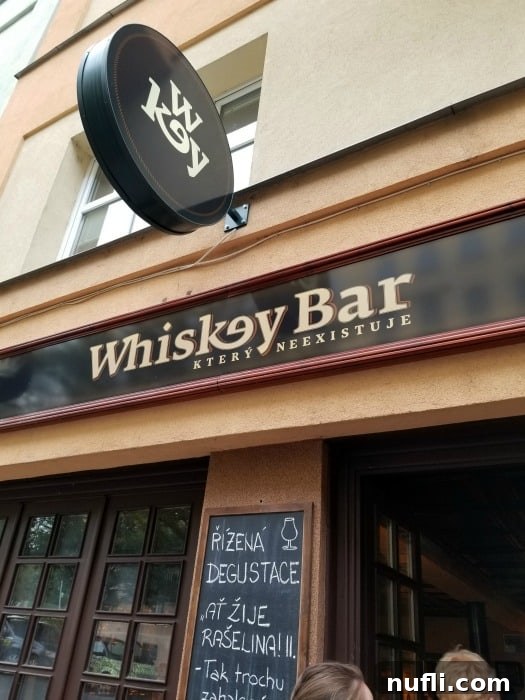 Whiskey Bar Ktery Neexistuje sign over bar entrance 
