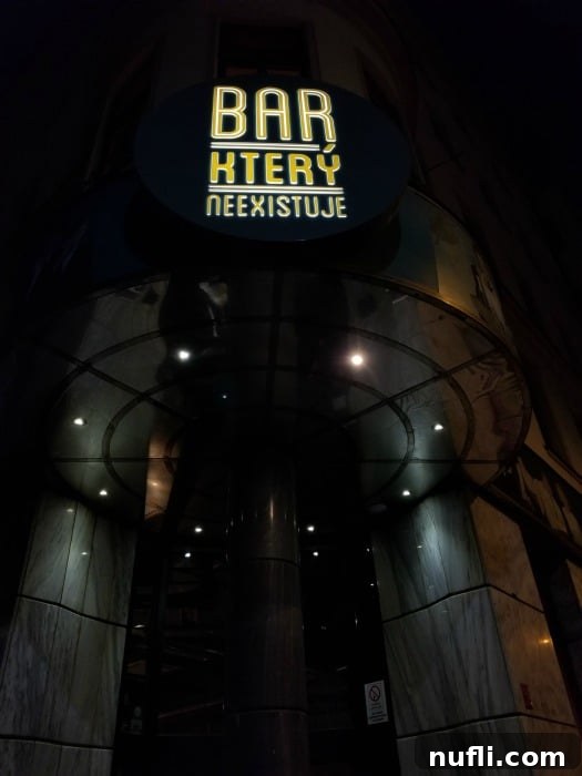 Bar Ktery Neexistuje sign over a restaurant entrance 