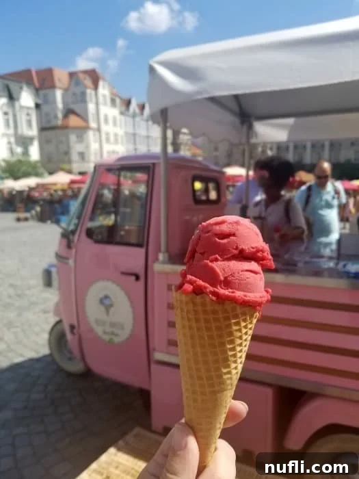 ice cream cone by a pink truck 
