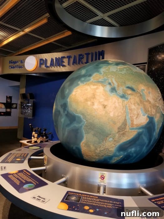 Large globe and space exhibit outside the entrance to the Grand Rapids Public Museum planetarium 