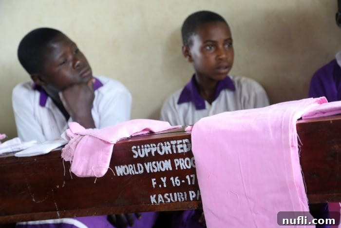 Uganda studen at tables from World Vision 