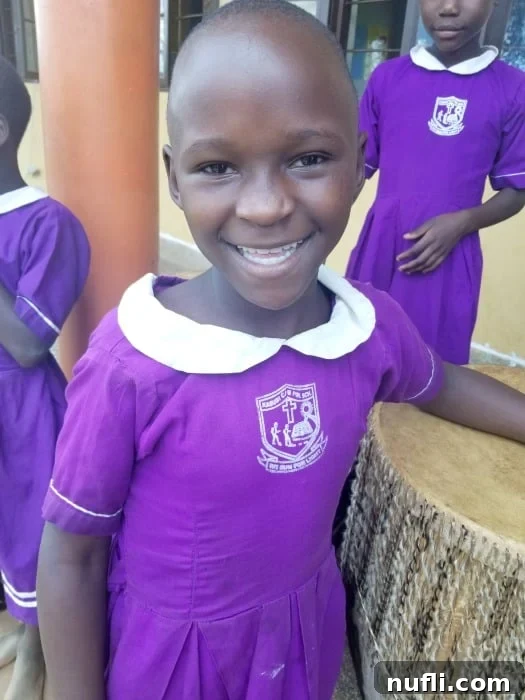 Smiling Uganda student in purple dress