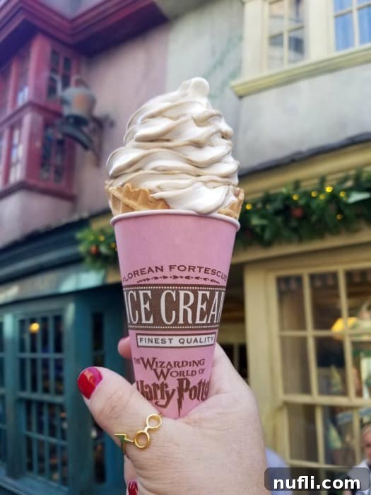 Hand holding a butter beer ice cream cone