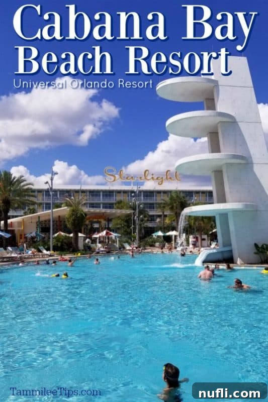 Aerial view of Cabana Bay Beach Resort with a bright blue pool and the Starlight sign above the hotel buildings, under a clear sky