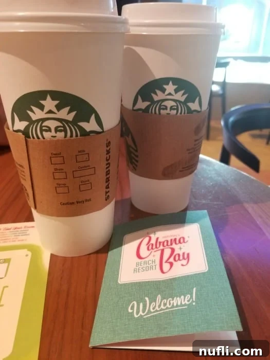 Starbucks cups next to a Cabana Bay Resort key holder, indicating convenient coffee access