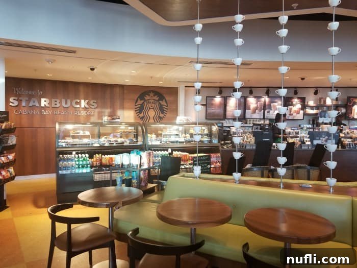 Interior of a Starbucks coffee shop with comfortable tables and chairs, ready for guests