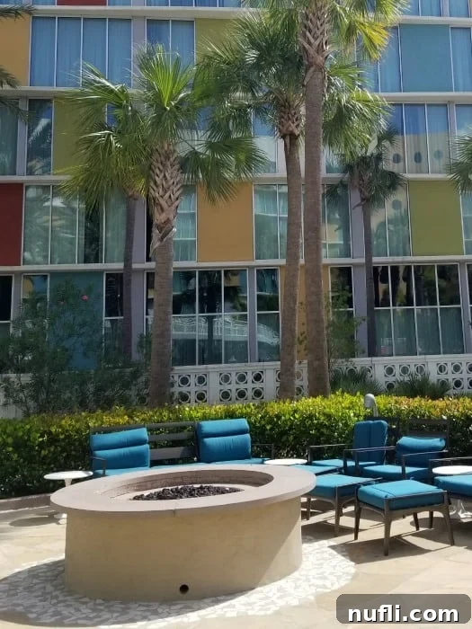 Inviting outdoor seating area with a cozy fire pit outside the Cabana Bay Resort, perfect for evening relaxation