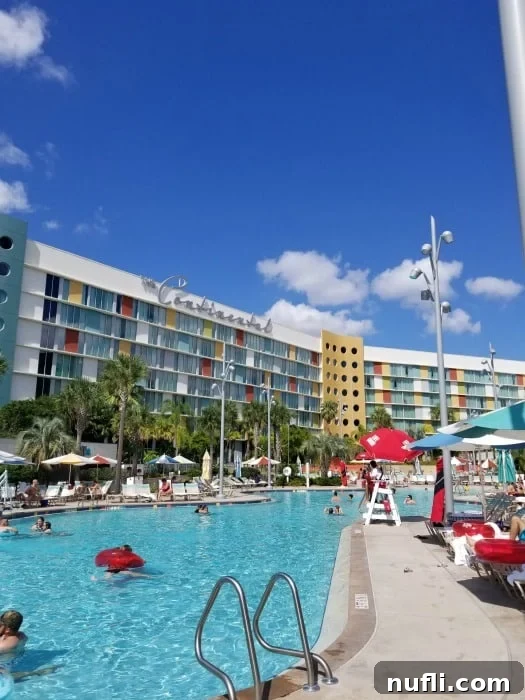 Cabana Bay Beach Resort pool with guests in the water, and the Continental Hotel sign visible in the background