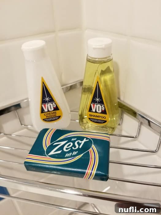 Mini bottles of VO5 creme rinse and shampoo, along with a small bar of Zest soap, on a bathroom counter