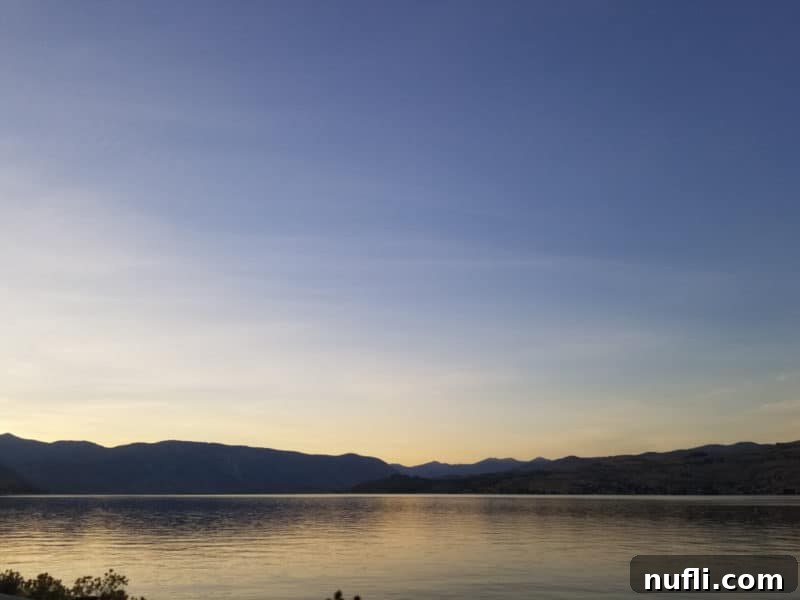 Serene Lake Chelan views with scattered clouds at dusk, creating a peaceful atmosphere
