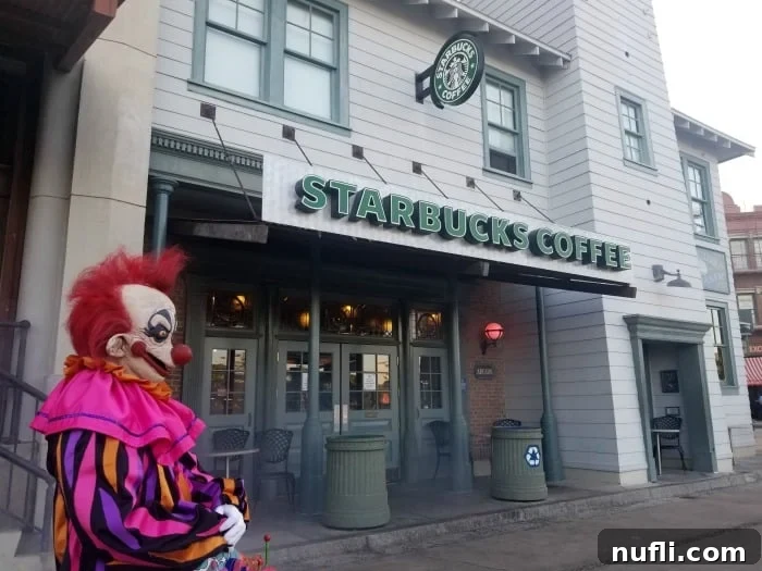 A scary clown scare actor standing outside a Starbucks at Universal Orlando, blending horror with everyday life