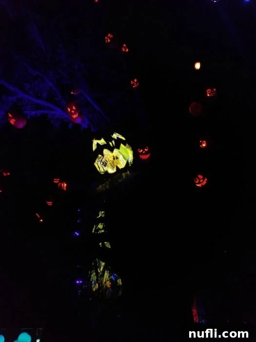 A cluster of glowing pumpkins in a dimly lit setting, part of a Halloween Horror Nights scare zone