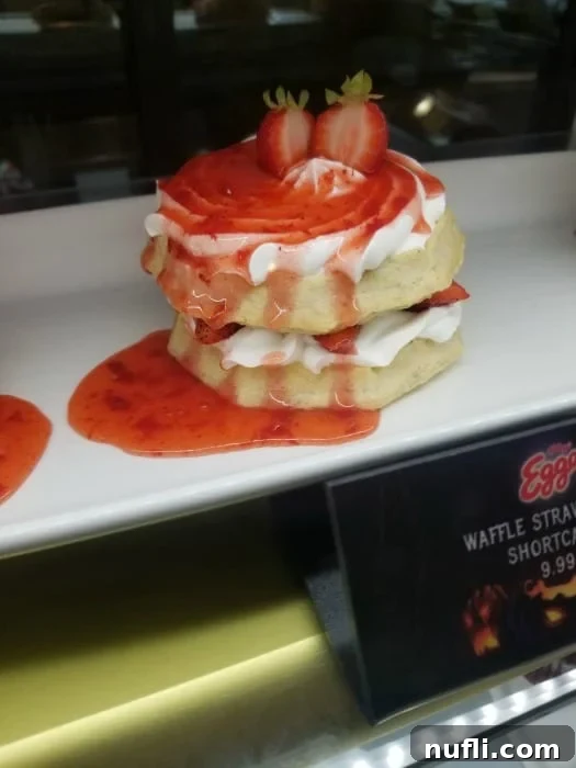 A delectable strawberry shortcake served on a pristine white platter