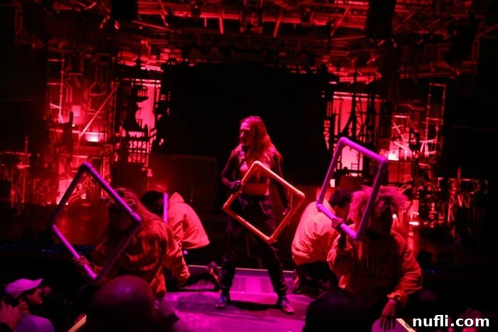 red stage with people holding squares 