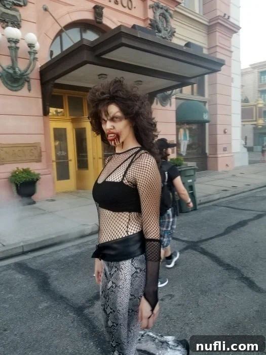 A scare actor at Universal Halloween Horror Nights with expertly applied fake blood on their face, creating a chilling effect