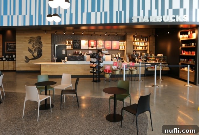 Aventura Hotel Universal Orlando Resort A Modern Getaway 5 Starbucks coffee shop interior with tables and chairs, ready for guests