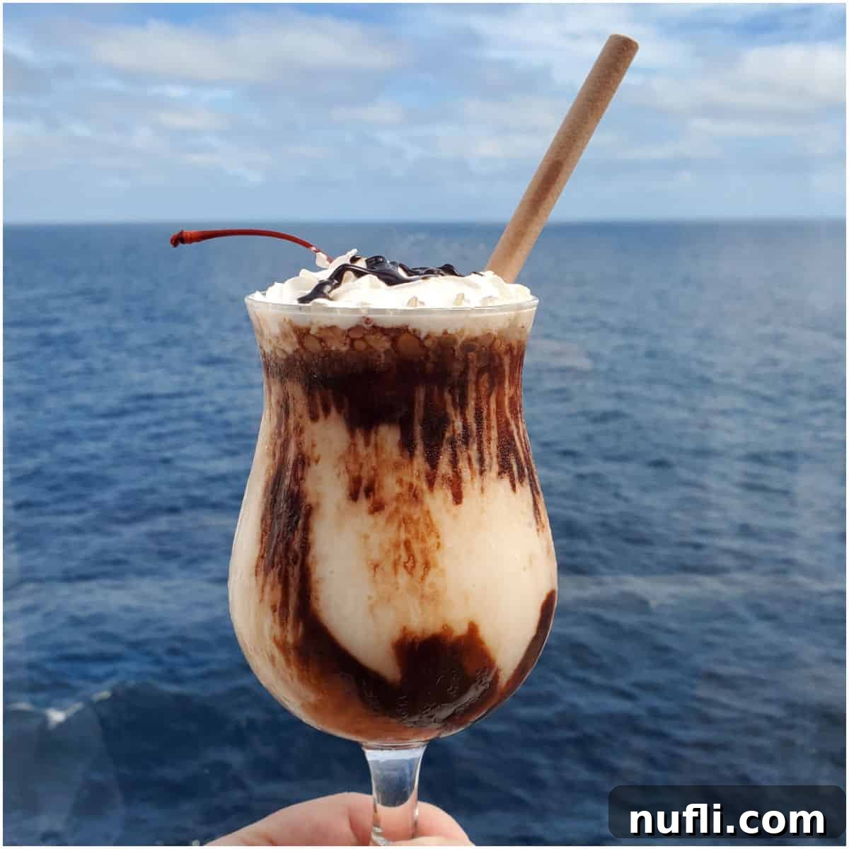Mocha Chocolate Getaway cocktail being held with a view of the ocean