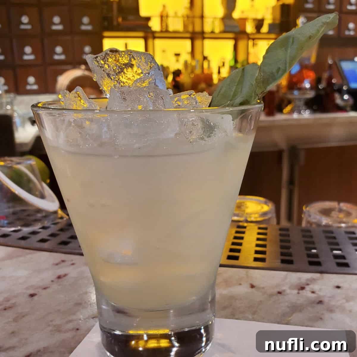 Restorative Basil Drop in a stemless martini glass with a basil garnish