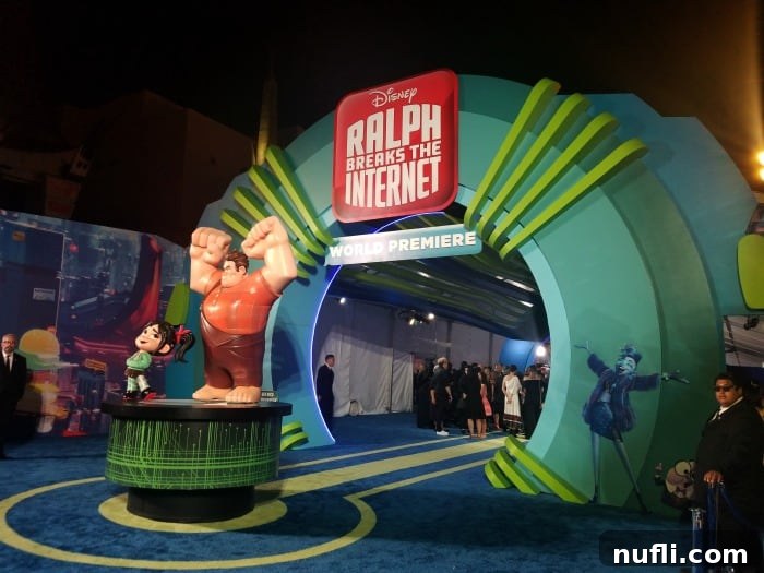 Ralph Breaks the Internet Premieres in Los Angeles 2 Ralph Breaks the Internet World Premiere sign over a blue carpet with large figurines of Wreck-It Ralph and Vanellope von Schweetz