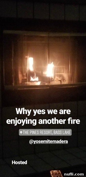 The Pines Resort - Bass Lake, California: A Video Tour 5 Fire burning warmly in a rustic brick fireplace within a resort room