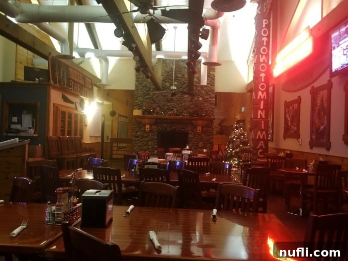 The Pines Resort - Bass Lake, California: A Video Tour 7 Ducey's Bar with tables and chairs and a stone fireplace, creating a cozy atmosphere
