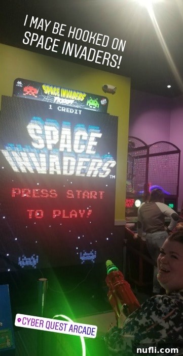 Tammilee playing Space Invaders in the arcade at Northern Quest Resort