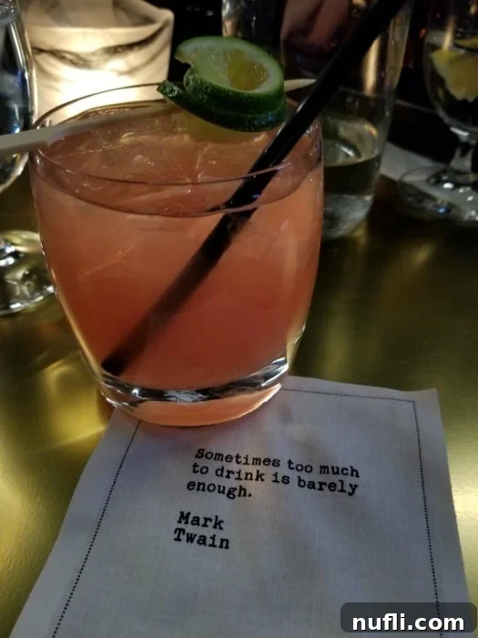 Elegant cocktail on a branded napkin with an inspirational quote