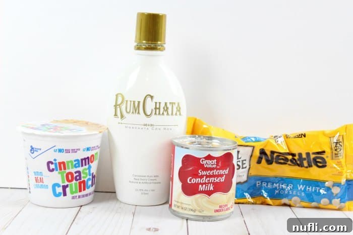 Decadent RumChata Fudge 4 Key ingredients for RumChata fudge—Cinnamon Toast Crunch, RumChata liqueur, sweetened condensed milk, and white chocolate chips—arranged appealingly on a table.