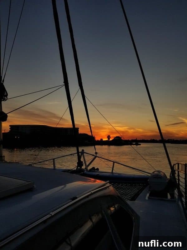 sunset from on a sail boat with ropes in front 