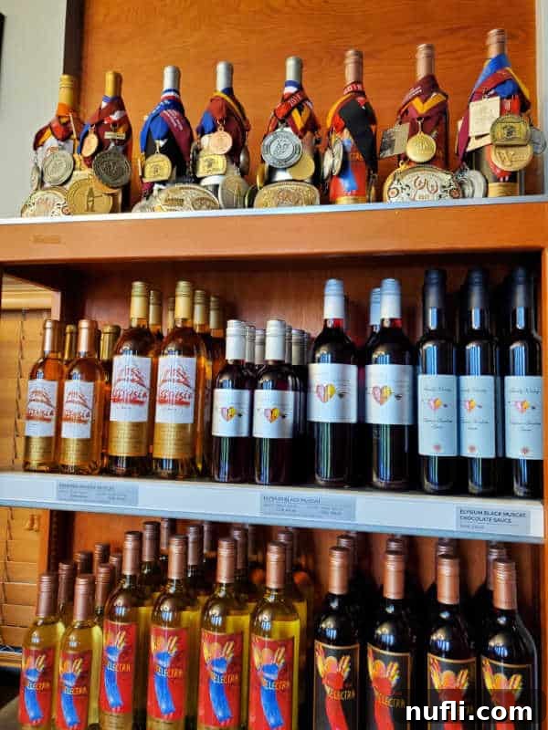 Rows of Quady Wine bottles displayed on three shelves, some adorned with award medals.